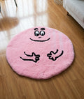 Barbapapa rug in pink with a smiling face, round tufted character mat styled on a wood bedroom floor
