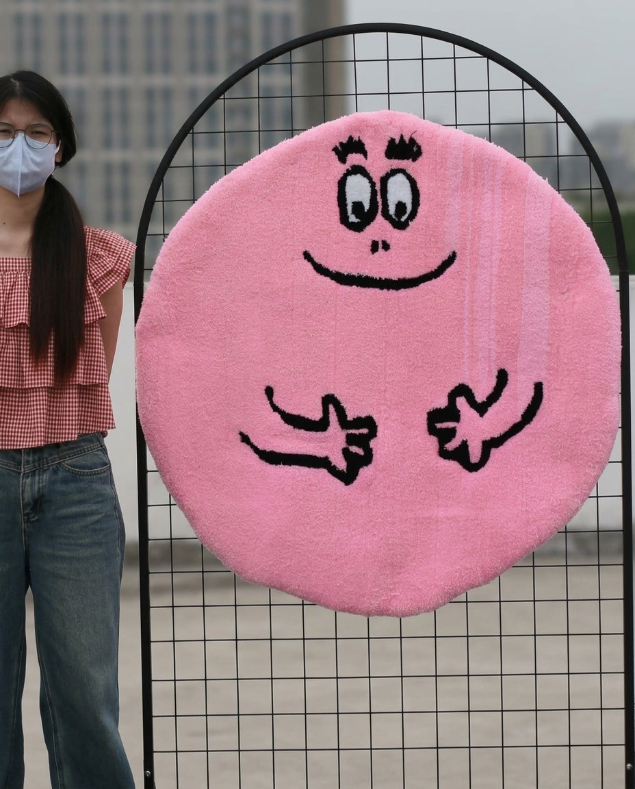 Round Barbapapa rug shown upright to display the cute pink face, soft high-density acrylic yarn