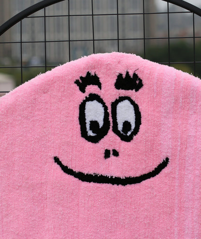 Close-up of the Barbapapa rug texture, showing tufted pink fur and black face detail