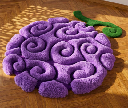 Hand tufted purple fruit area rug, raised swirl pile and green stem on parquet, close up detail