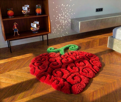 Shaped red fruit rug with curled green stem, dense acrylic tufted pile, styled living room view