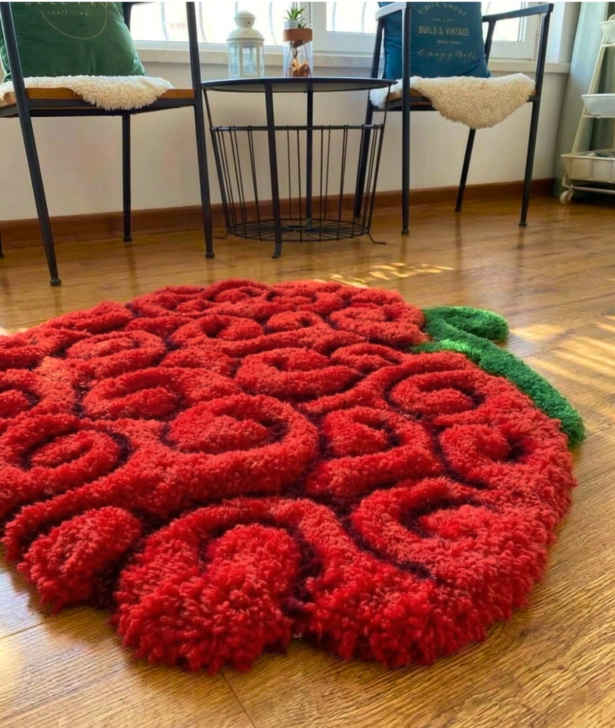 Anime fruit rug in a living room, thick red curl tufted acrylic pile on a wood floor, low angle