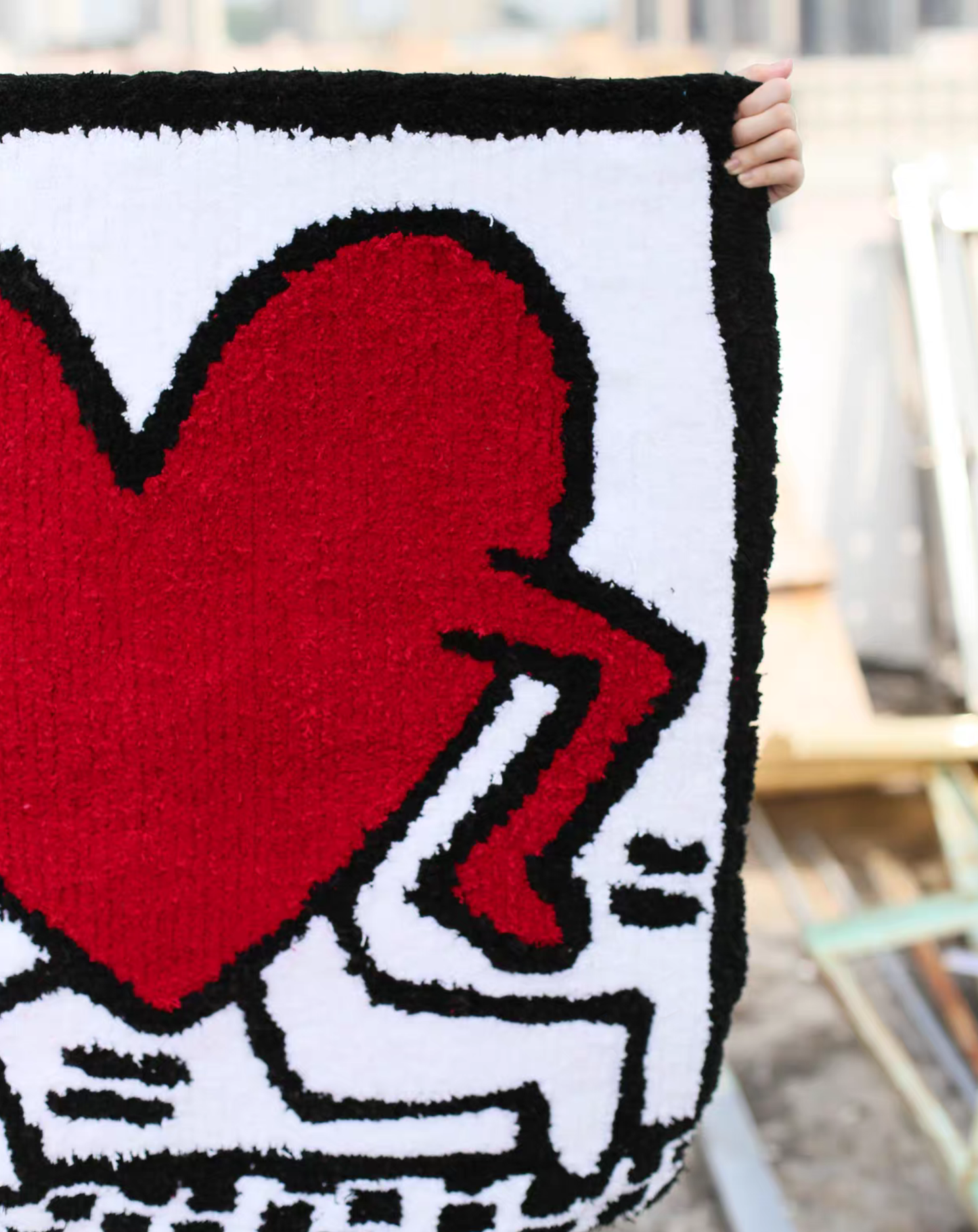 Keith Haring inspired heart rug close up acrylic yarn tufting detail street art aesthetic