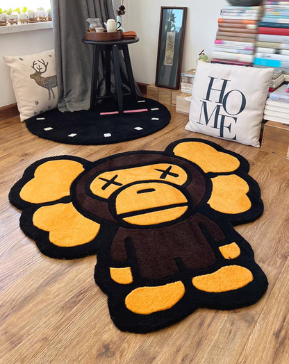 Kaws Bape Milo Character Rug Floor Placement, styled on a light wood floor in a cozy room setting with a clock rug and decorative pillows in the background.