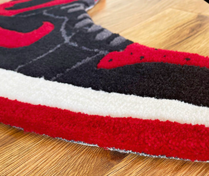 Close up of the sneaker rug midsole, layered red white and black tufted pile texture