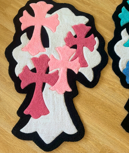 Close up of layered pink crosses on white with black trim, tufted yarn surface detail