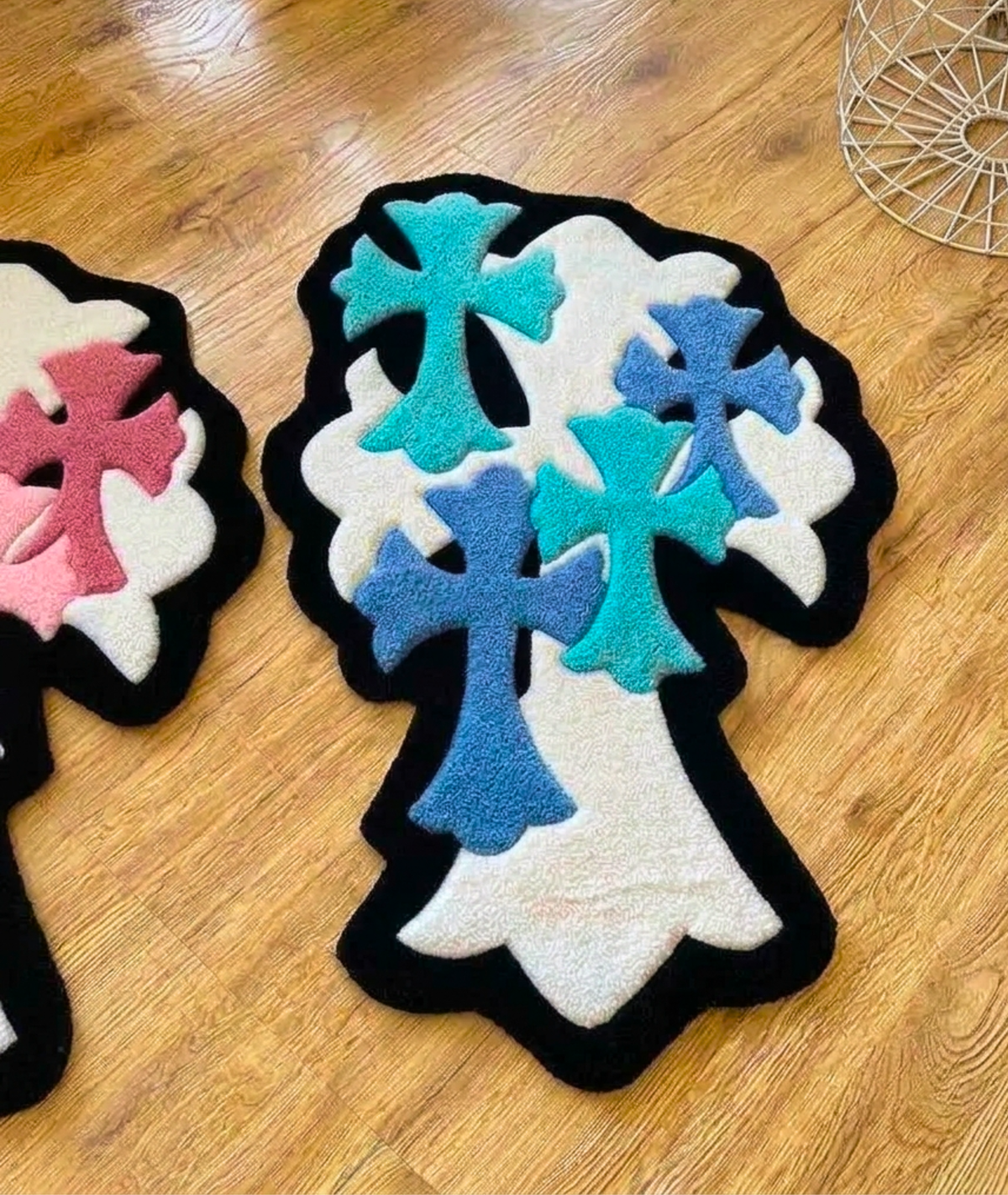 Teal and navy crosses layered on the shaped rug, soft acrylic pile on a wood floor