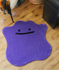 Purple blob rug with a smiling face on a wood floor, hand tufted cute room decor, full top view