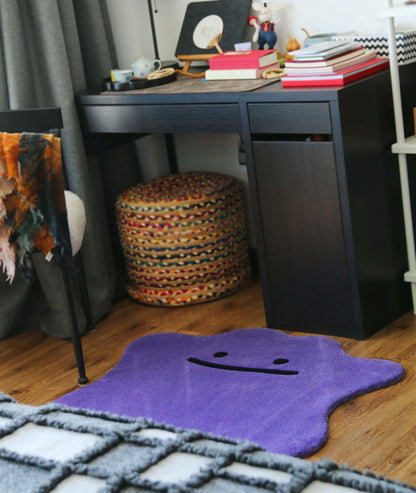 Purple smiley face rug in a study corner, soft tufted floor decor beside a desk, room view