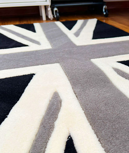 Close up of the flag rug bars, dense cream grey and black tufted yarn surface detail