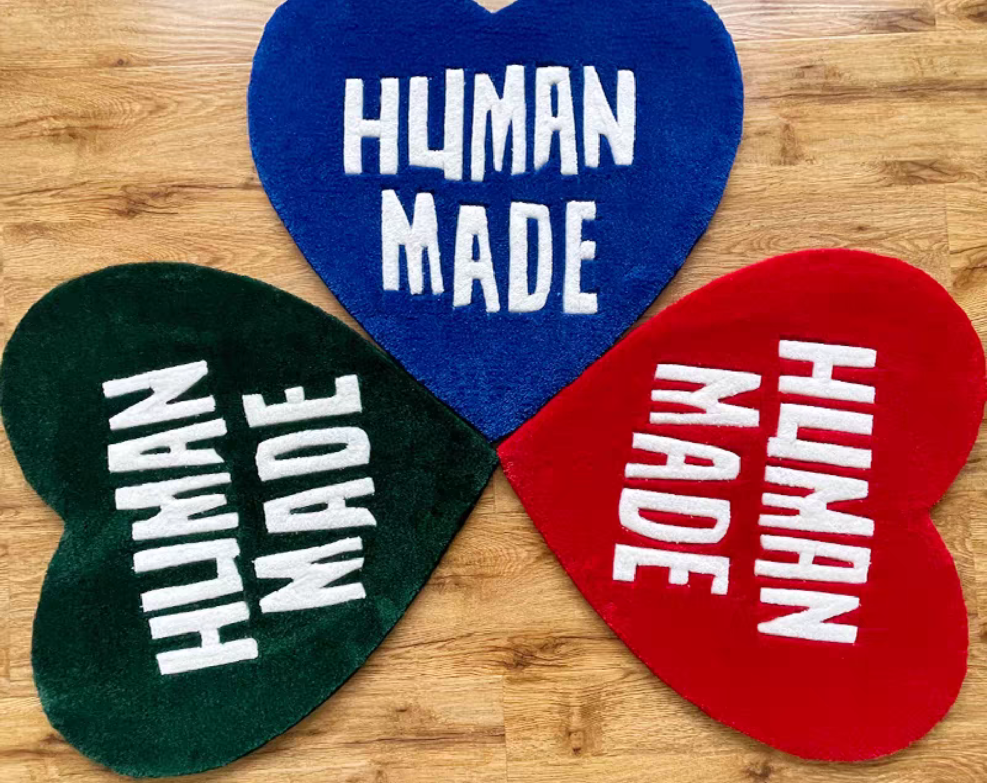 Human Made heart rug bundle green red blue colorways. Hand-tufted streetwear accent carpets for sneaker room. Hypebeast bedroom gaming home decor collection.