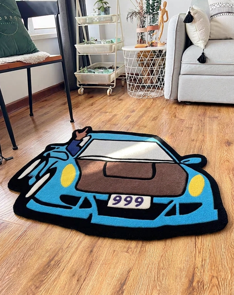 Gaming room rug shaped like a blue car with 999 plate, styled in a living room next to a sofa and chair
