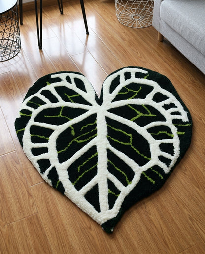 Leaf vein pattern in white and lime green on a plush black rug, close angled floor shot