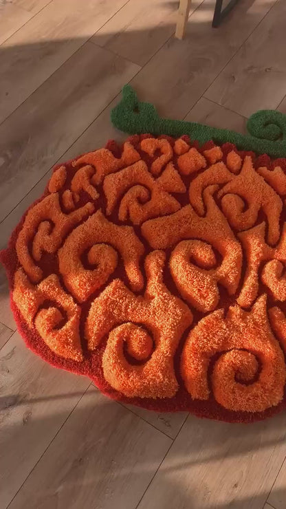 Orange swirl fruit rug video, soft acrylic tufted pile with green stem, close up floor view