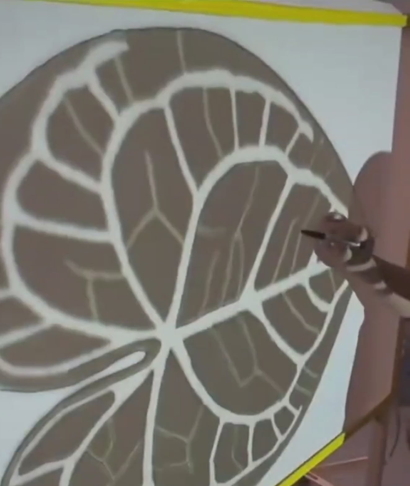 Video of the leaf rug being hand tufted, design outline on the frame during making