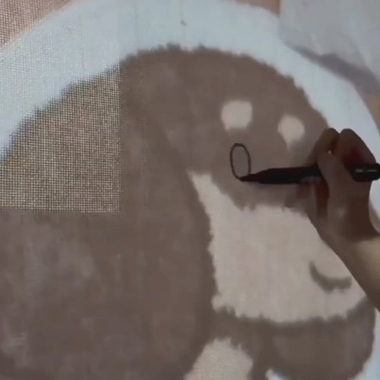 Video of the dachshund rug being made, design drawn on the tufting cloth by hand
