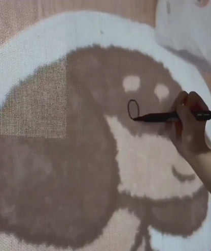 Video of the dachshund rug being made, design drawn on the tufting cloth by hand