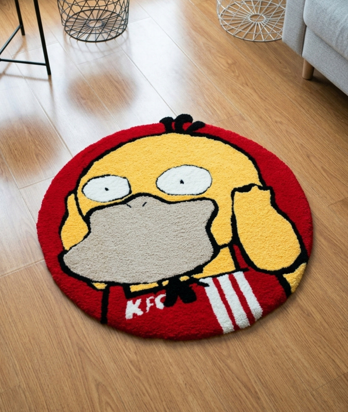 Psyduck rug in yellow and red, round tufted anime mat styled on a wood bedroom floor
