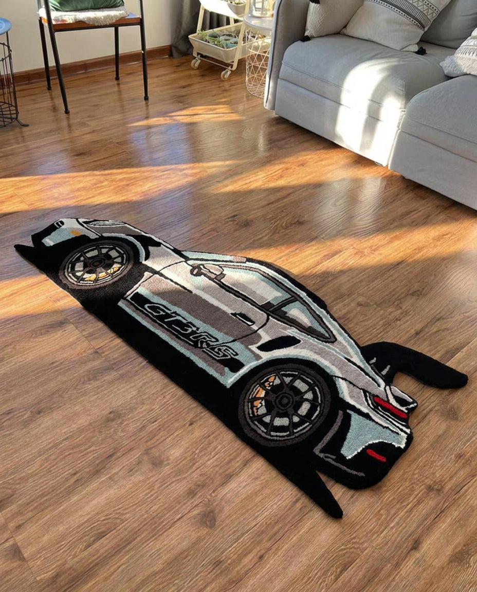 Sports Car Rug hand tufted silver and black car shaped rug with rear wing, top view on a wooden floor