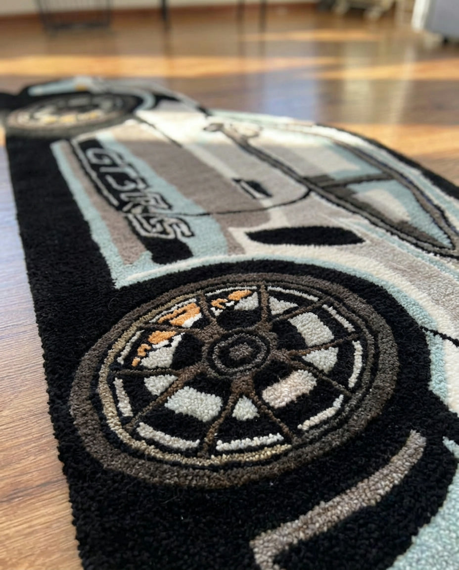 Hand tufted sports car rug close up of side stripes, wheel and thick acrylic pile on a hardwood floor