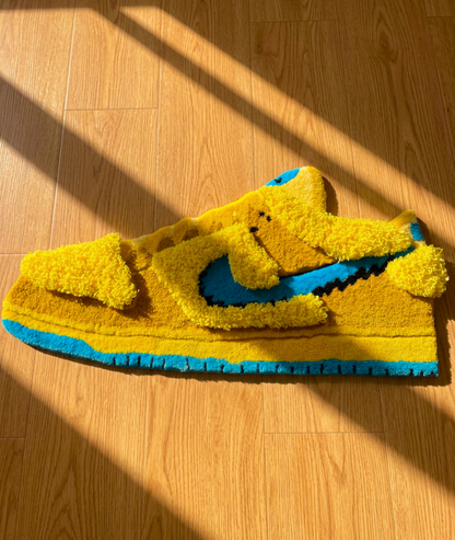 Novelty sneaker rug for a dorm or gaming room, soft yellow and blue acrylic yarn, angled floor view